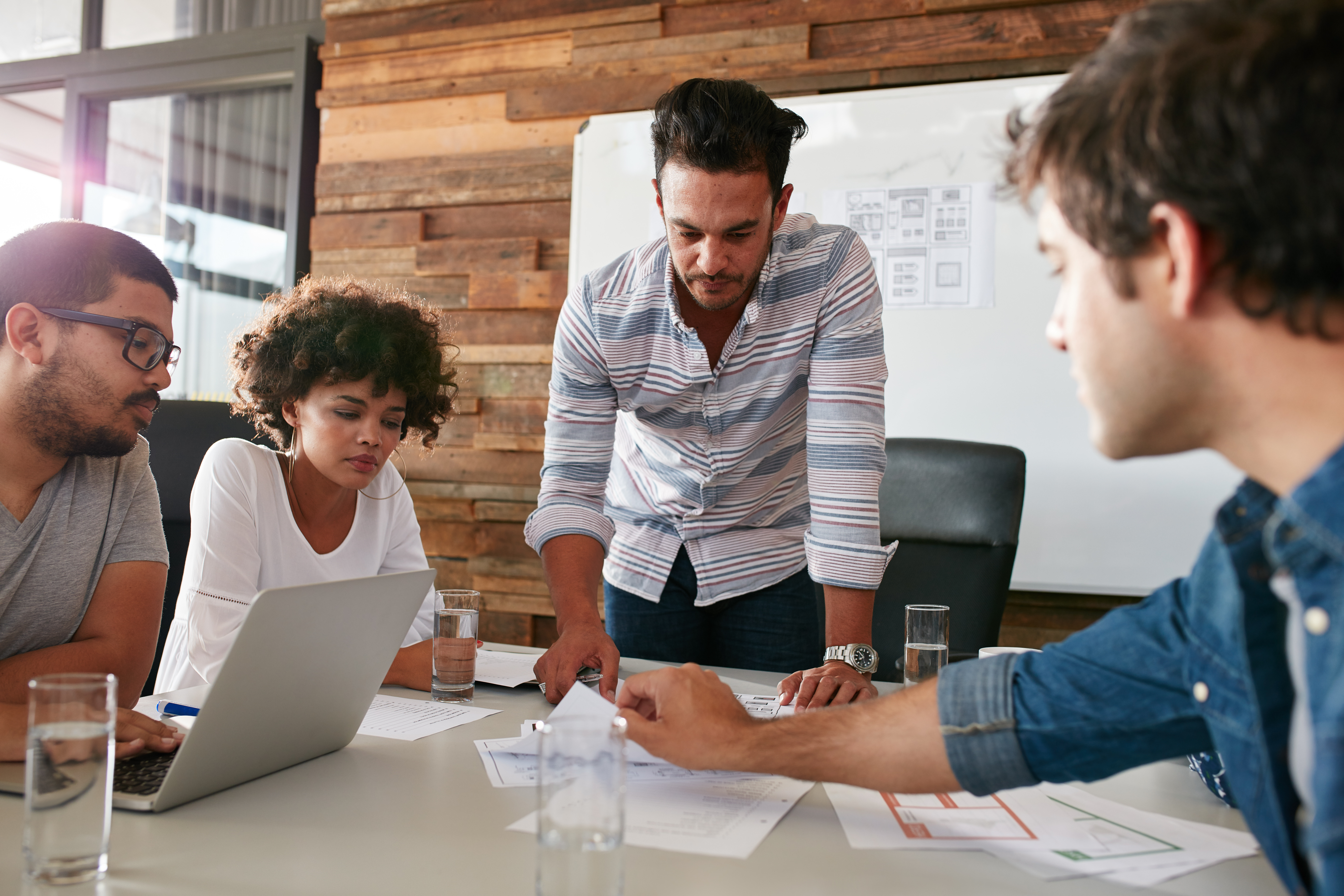 Four people in a business meeting discussing how to improve their online presence.